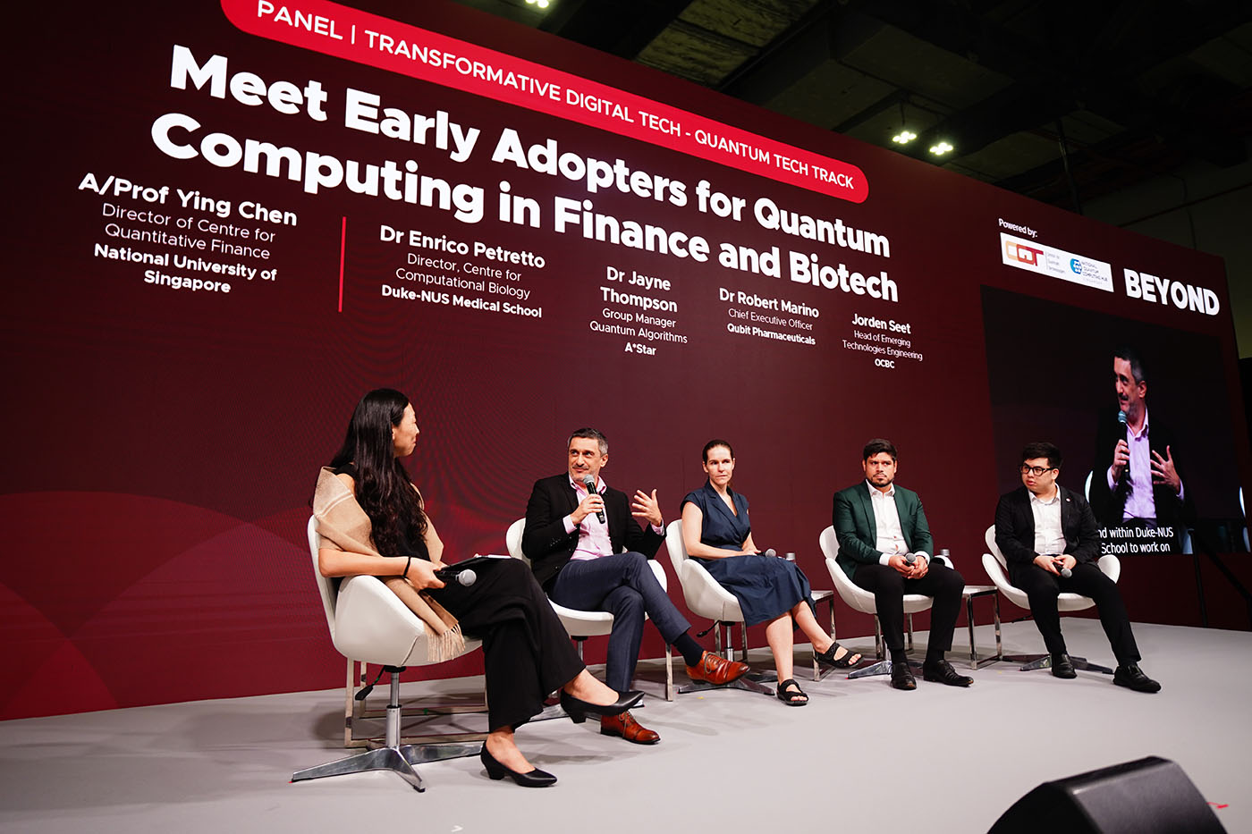 Photo of panel discussion at SWITCH 2024 - five people sit under the headling "Meet Early Adopters for Quantum Computing in Finance and Biotech"